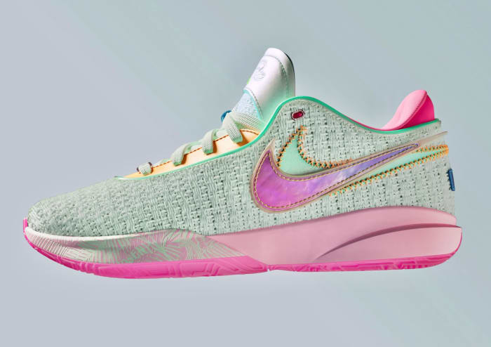 View of pink and teal Nike LeBron 20 shoes.